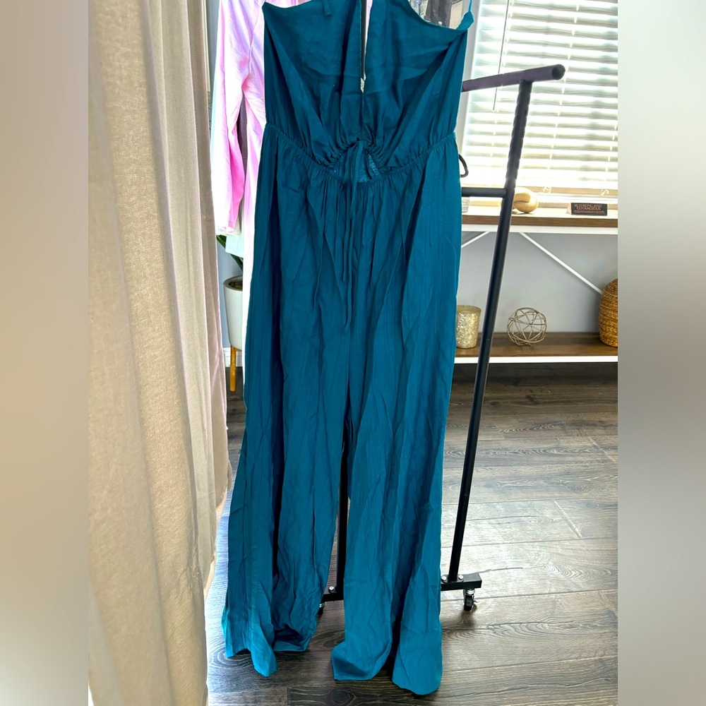 Aqua jumpsuit worn 3-4 times. Size Medium.  Adjustable strings.